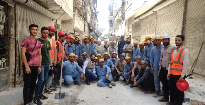 a group image of workers in a street