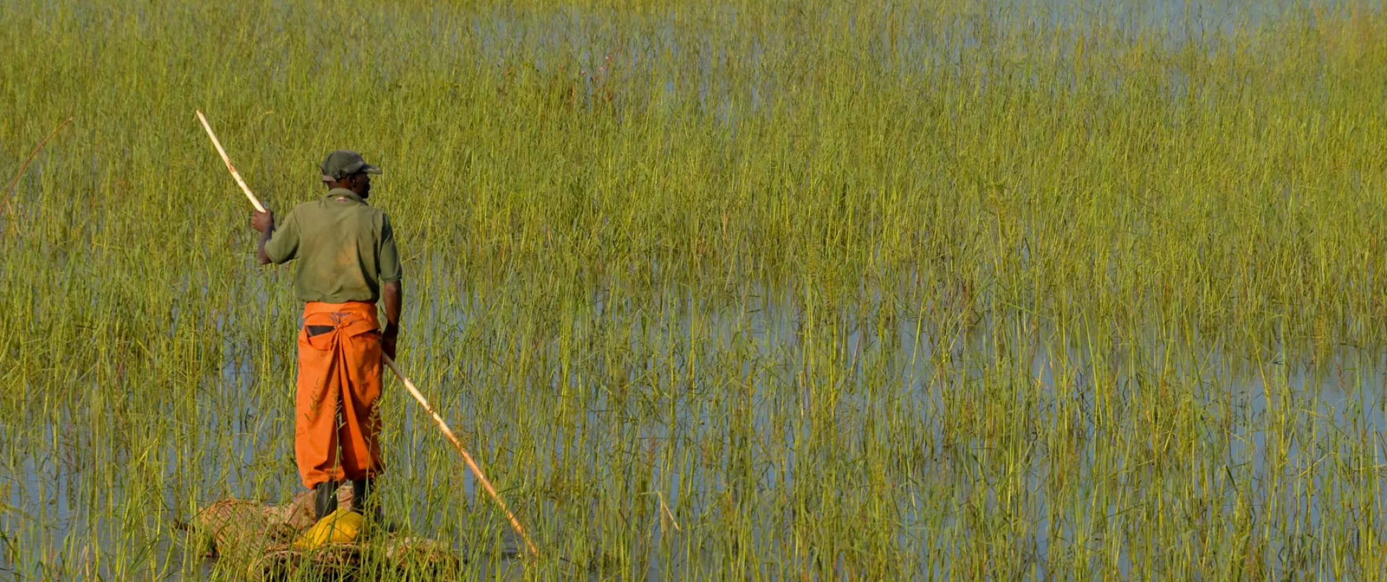 Man standing on a raft in Lunda Norte Province, Angola