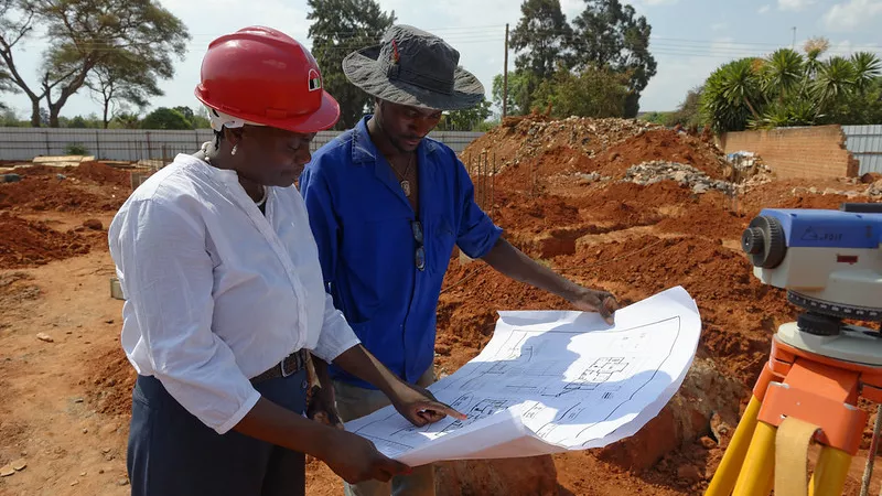 Architect looking at a plan with a colleague in Lusaka, Zambia