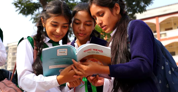 Bangladeshi students admire their new textbooks provided by the Government