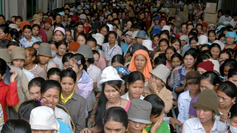 A huge crowd of Cambodian garment workers leave the factory