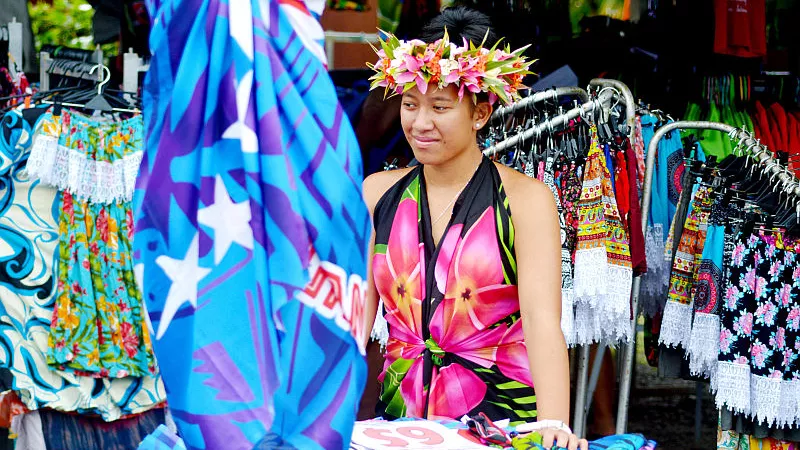 A Cook Islander woman selling clothes at Punanga Nui Market in Avarua town of Cook Islands