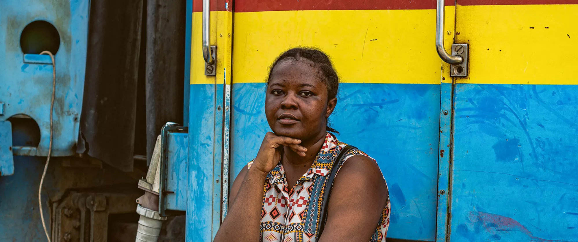 Woman sitting in front of a painted train