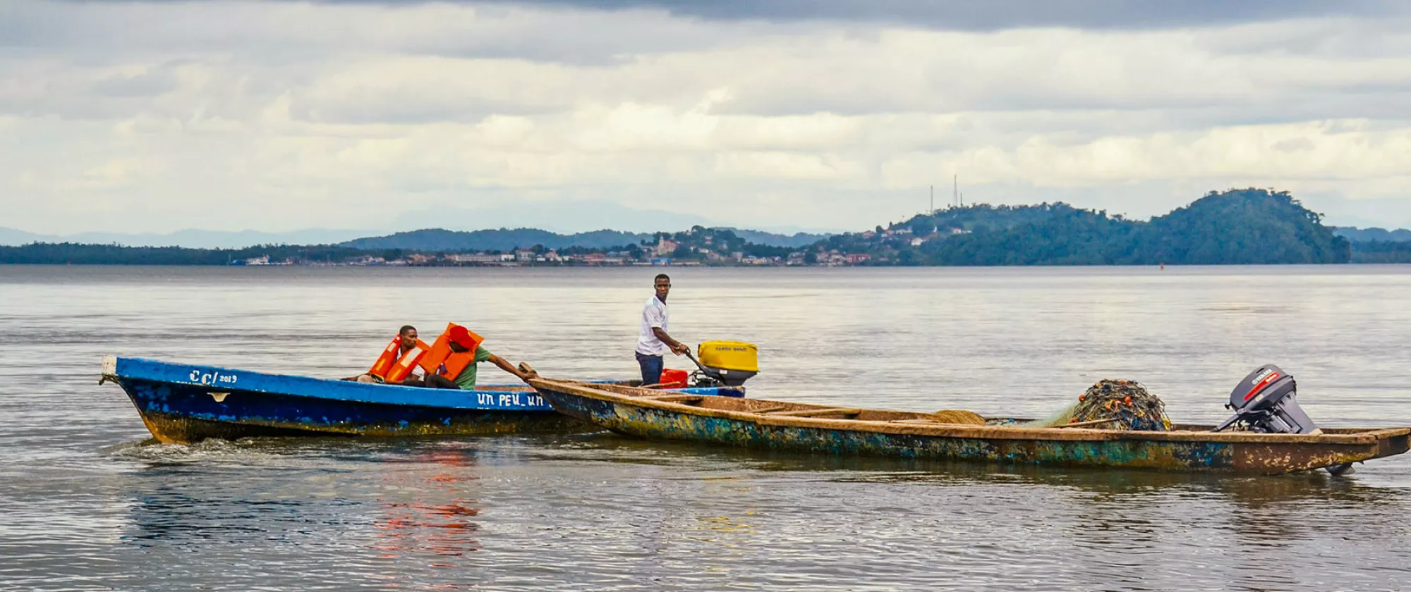 People on two boats in Gabon