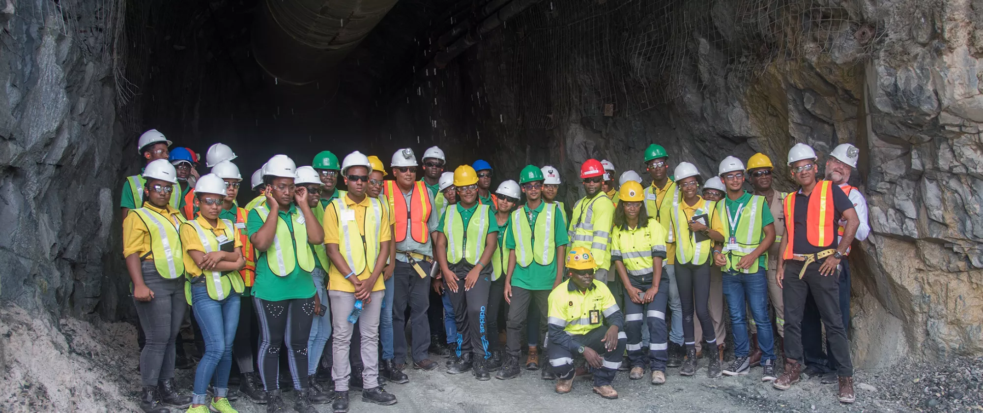 Group of apprentices in front of the underground exploration tunnel in Guyana