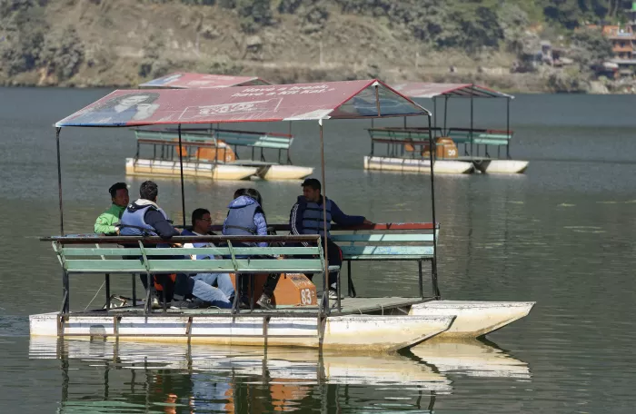 Tourists on a small river boat in Nepal