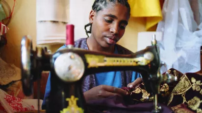 Woman tailor in Ethiopia with a hearing impairment at work.