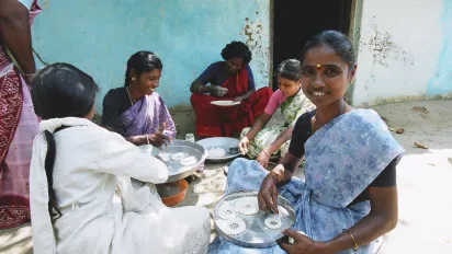 A group of girls smiling and holding plates.