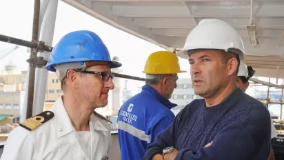 Workers onboard of a ship in the port of Genoa